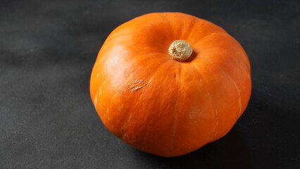 Autumn still life with pumpkin on black background
