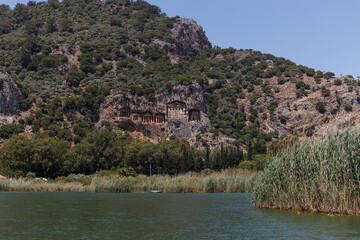 Archaeological remains of the Lycian rock cut tombs. Lycian Tombs. Unique ancient necropolis. Ancient Greek burials. Tourism and attractions. River Dalyan, Turkey. Lycian Tombs Of Caunos