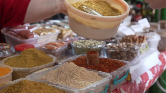 woman showing spices to a customer in the local market, Kutaisi, Georgia. High quality 4k footage
