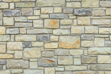 Solid yellow and beige stone wall. Stone background.