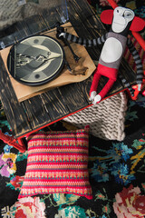 ukrainian art, red decorative table, knitted rug with pillows