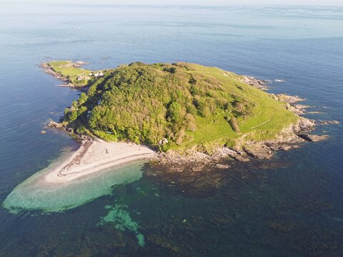 Aerial drone. Crystal clear turquoise water at St Georges Island near Looe, picturesque seaside village. Cornwall, Southwest England, United Kingdom.