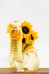 Bottle of sunflower oil with flower isolated on white background