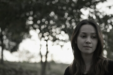 Front view point of young woman thoughtful and lonely emotion with beautiful bokeh