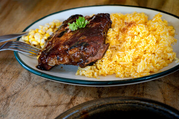 Baby back rib served with yellow rice