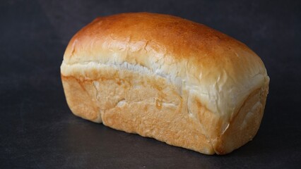 Top view loaf of bread isolated on black background.