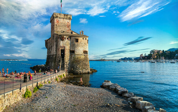 Italy Liguria Rapallo Ancient Sea Castle Standing on Small Sandy City Beach with Turquoise Water Medieval Fortress and Promenade at Pre-sunset Golden Hour