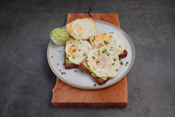Avocado fried egg sandwich with bread on wooden floor home made