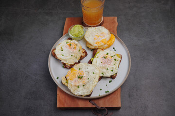 Avocado fried egg sandwich with bread on wooden floor home made