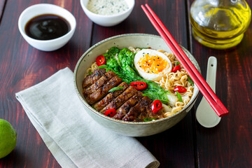 Ramen soup with duck, noodles, cabbage, pepper and egg. Asian food.