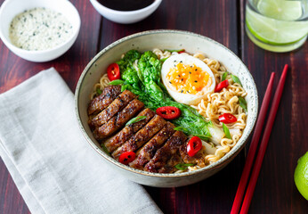 Ramen soup with duck, noodles, cabbage, pepper and egg. Asian food.
