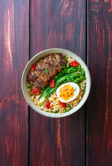 Ramen soup with duck, noodles, cabbage, pepper and egg. Asian food.