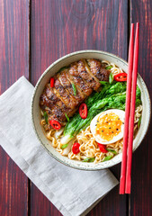 Ramen soup with duck, noodles, cabbage, pepper and egg. Asian food.