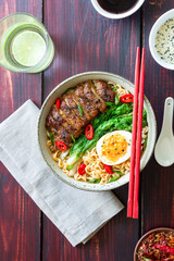 Ramen soup with duck, noodles, cabbage, pepper and egg. Asian food.