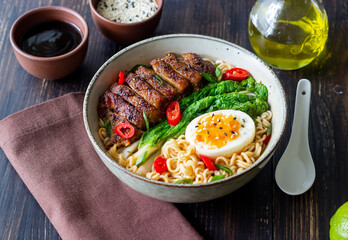 Ramen soup with duck, noodles, cabbage, pepper and egg. Asian food.