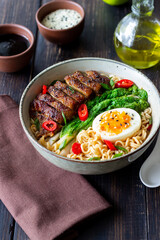 Ramen soup with duck, noodles, cabbage, pepper and egg. Asian food.
