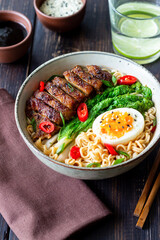 Ramen soup with duck, noodles, cabbage, pepper and egg. Asian food.