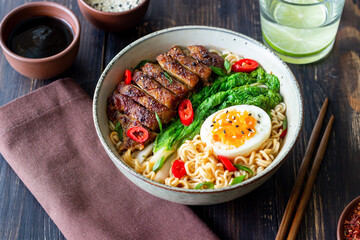 Ramen soup with duck, noodles, cabbage, pepper and egg. Asian food.