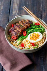 Ramen soup with duck, noodles, cabbage, pepper and egg. Asian food.