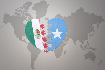 puzzle heart with the national flag of somalia and mexico on a world map background.Concept.