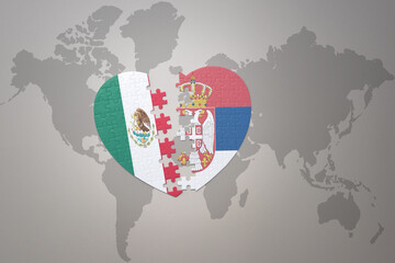 puzzle heart with the national flag of serbia and mexico on a world map background.Concept.
