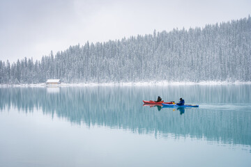 Two kayaks on azure alpine lake during early winter, Banff N. Park, Canada
