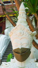Statues of angels wearing masks to prevent covids from tourists