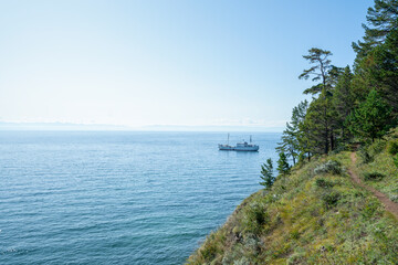 Lake Baikal coast, hill with forest, water bay. Summer travel, discovery of beauty of Earth. Siberia, Russia.