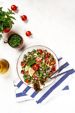 Middle eastern or arab dishes and assorted meze and snacks tabbouleh vegetable salad, olives, tomatoes, pomegranate, herbs. Traditional oriental salad Tabouleh