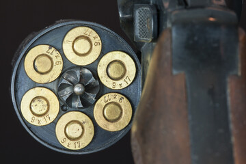 Loaded drum of a revolver. The revolver belongs to the category of multi-shot handguns and the cartridges are loaded in the rotatable drum.