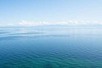 Landscape with the coast of Lake Baikal in calm clear weather .