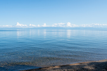 Landscape with the coast of Lake Baikal in calm clear weather .
