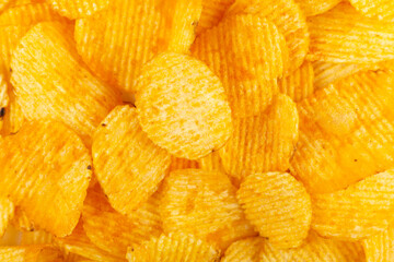 Crispy potato chips close up snack texture background