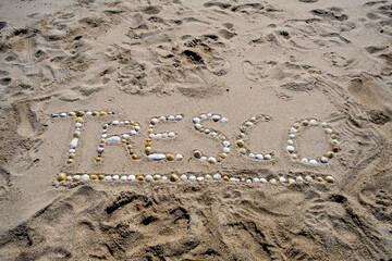 Tresco writing on the beach in shells and pebbles Isles of Scilly cornwall uk 