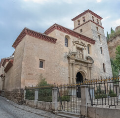 View at the San Pedro and San Pablo Church, Mudejar and Renaissance styles, on Carrera del Darro to the street sad walk in Granada, Spain