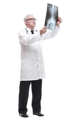 full-length. qualified mature doctor looking at the x-ray.