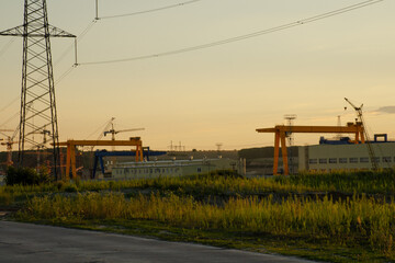 Yellow gantry overhead crane for cargo and construction work sunset