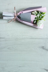 A bouquet of flowers on a white wooden background. Mother's Day. International Women's Day. The concept of the holiday