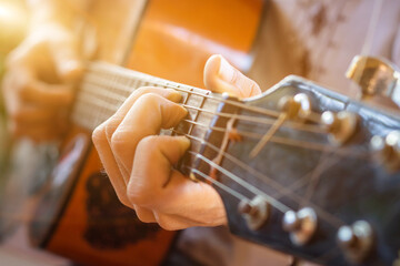 close up hand of people playing guitar,man playing acoustic guitar. Selective focus - obrazy, fototapety, plakaty