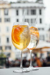 Two glasses of Spritz cocktail served on the terrace of urban bar. Popular Italian wine based...