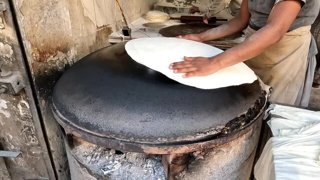 cooking huge bread or roti on huge griddle 4k high resolution video
