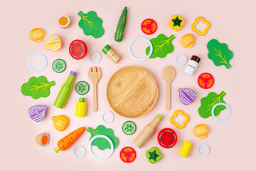 Plate with salad ingredients. Wooden fruit and vegetables play set. Game for learning and development of the child. Cute kids toys to play in the kitchen. Healthy food concept