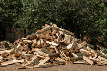 Firewood chopped with an ax for the stove lies in a heap in the yard. Chopped glades