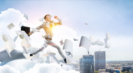 Portrait of energetic businessman jumping in open air