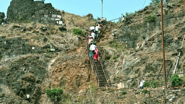 Kolhapur, Maharashtra  India - May 7 2022: shot people climbing fort on southern Maharashtra
