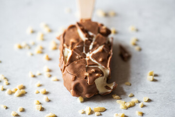 Cracked vanilla almond ice cream with chocolate glaze, close up.