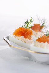 Appetizer of stuffed eggs stuffed with salmon pate and yolks with salmon slices. Holiday table idea
