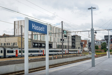 Fototapeta na wymiar Train platform at Hasselt city railway station in Belgium. City name lettering on the platform