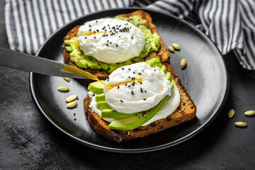 Sandwiches with avocado and poached egg. Healthy food, keto diet, diet lunch concept. Top view