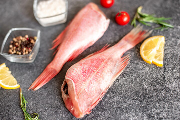raw red sea bass on stone background